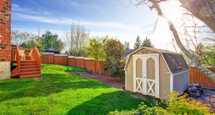 Fenced backyard with storage shed in Davenport